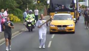 Woodbridge tennis club coach running with the Olympic Torch in Suffolk