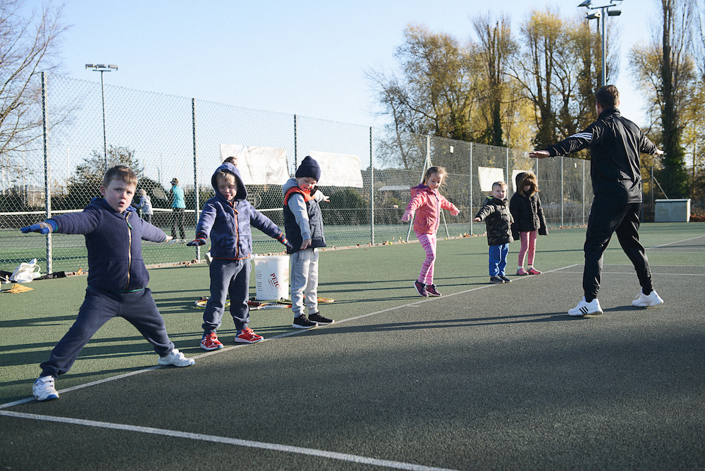 Warm up on court at Mini Red tennis session