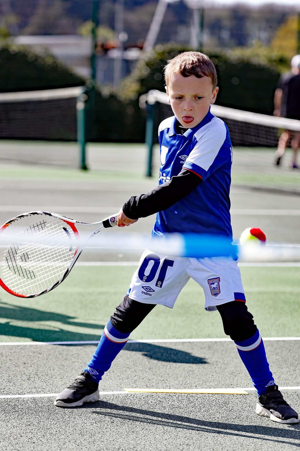 Junior Tennis Player at Woodbridge Tennis Club, Suffolk - aiming for the ball